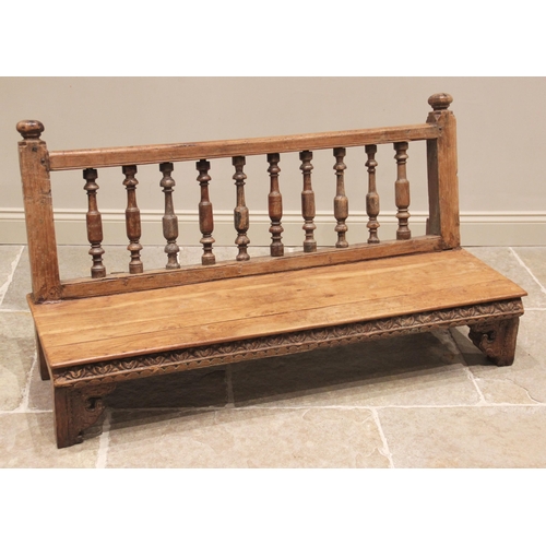 772 - An Anglo-Indian hardwood bench, the balustrade spindled back rest upon a board seat raised upon plai... 