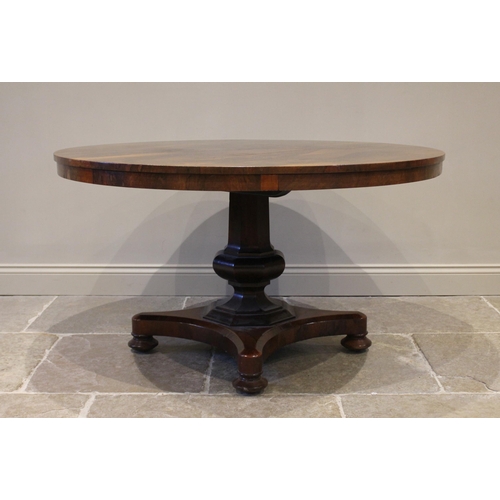 778 - A William IV rosewood breakfast table, the circular tilt top raised upon an octagonal column termina... 