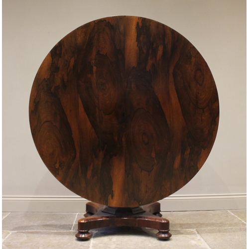 778 - A William IV rosewood breakfast table, the circular tilt top raised upon an octagonal column termina... 