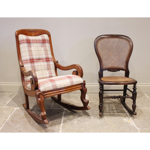 779 - A Victorian mahogany framed rocking chair, the scroll arms enclosing a drop in upholstered seat, bel... 