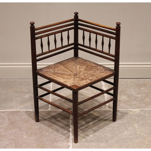 780 - A 19th century corner chair, in the manner of Morris & Co, Sussex, the angular back rest with taperi... 