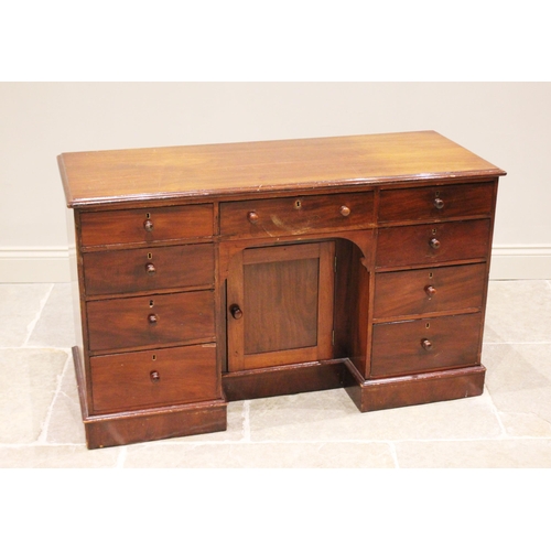 785 - A Victorian mahogany dressing table/desk, the rectangular moulded top above a central recessed cupbo... 