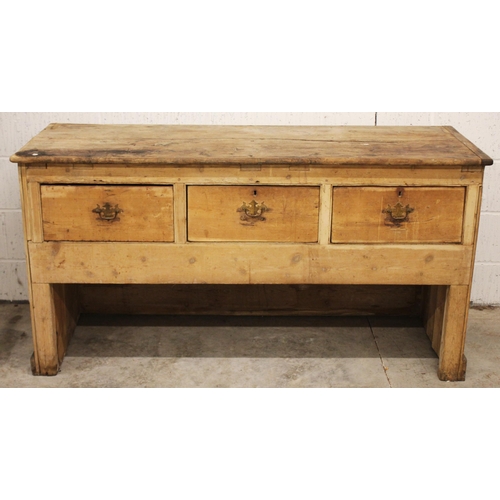 798 - A Victorian pine work bench/dresser, the plank top above three frieze drawers, upon panelled end sup... 