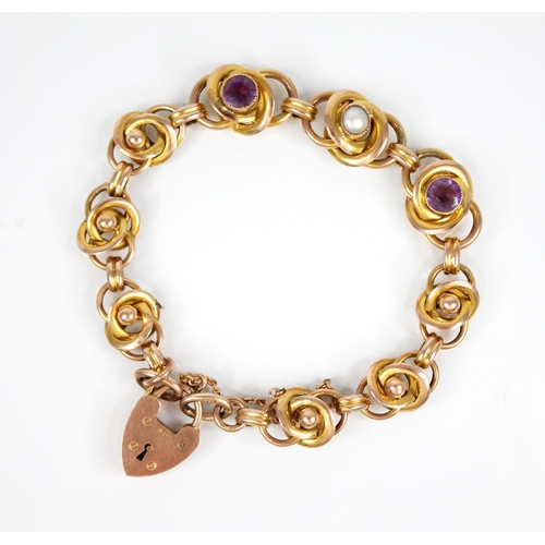 81 - An Arts & Crafts gold coloured amethyst and pearl set bracelet, designed as interwoven knot links, t... 