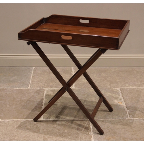 811 - A mahogany butlers tray and associated stand, 19th century, the galleried tray with hand apertures u... 