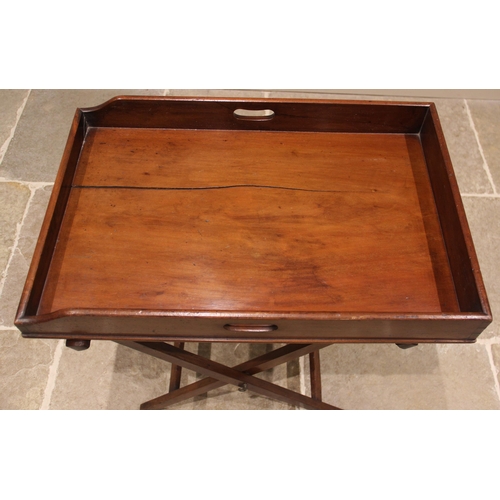 811 - A mahogany butlers tray and associated stand, 19th century, the galleried tray with hand apertures u... 