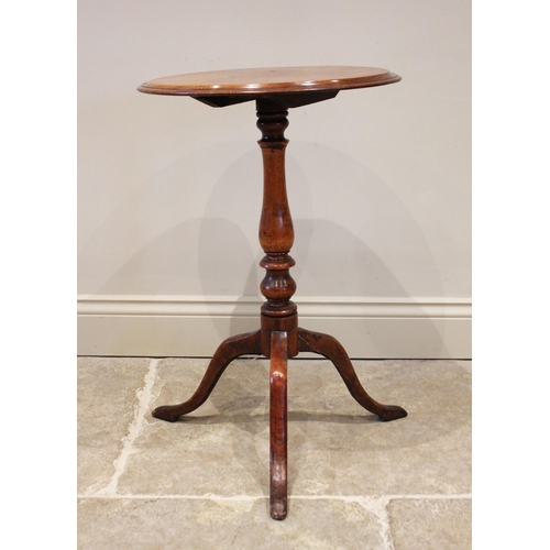 816 - A 19th century mahogany tilt top wine table, the circular top supported by a baluster carved column ... 