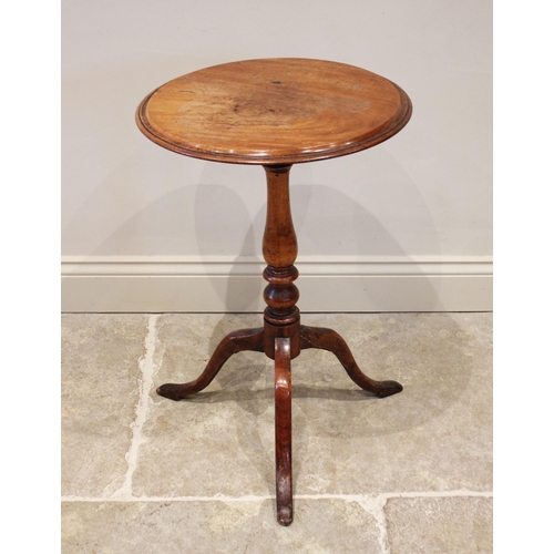 816 - A 19th century mahogany tilt top wine table, the circular top supported by a baluster carved column ... 