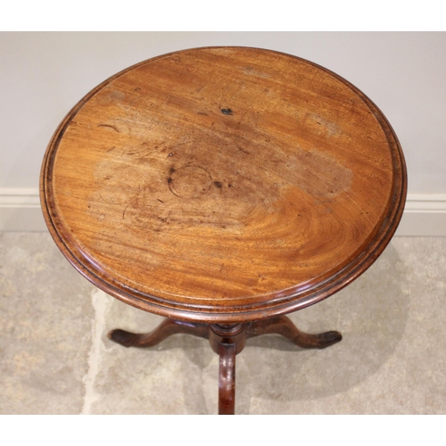 816 - A 19th century mahogany tilt top wine table, the circular top supported by a baluster carved column ... 