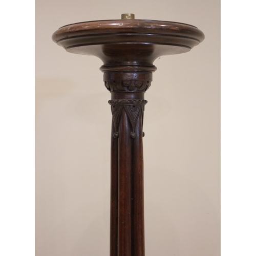 819 - A 19th century mahogany torchere/standard lamp, the circular rimmed top raised upon a cluster column... 