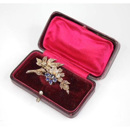 82 - A Victorian diamond and sapphire floral spray brooch, the floral head comprising five mixed cut sapp... 