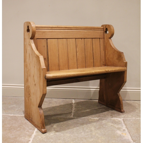 825 - A Victorian pine pew, of cottage proportions, the panel back and board seat raised upon shaped suppo... 