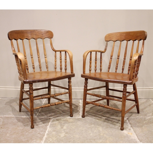 830 - A near pair of Victorian ash, elm and beech spindle back elbow chairs, each formed with a concave to... 