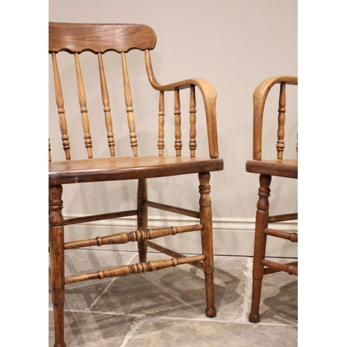 830 - A near pair of Victorian ash, elm and beech spindle back elbow chairs, each formed with a concave to... 