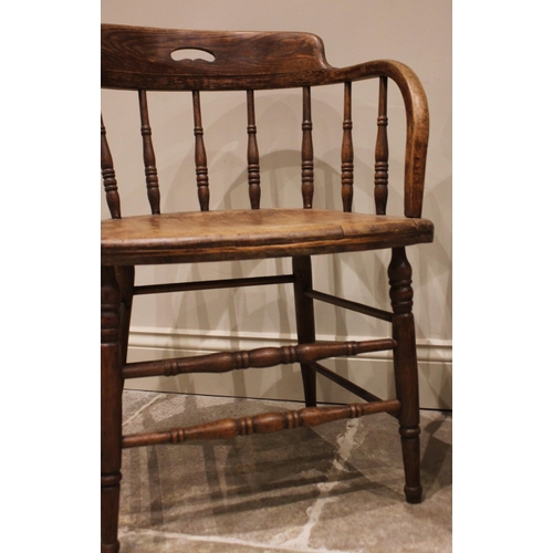 835 - A 19th century oak and ash captain's chair, with spindle back below a top rail with hand aperture, r... 