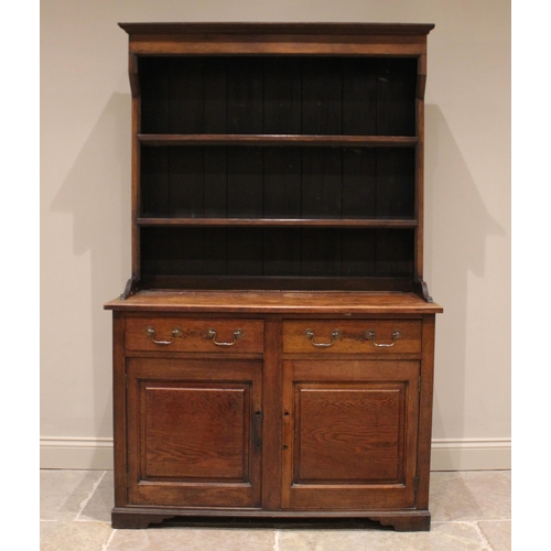 836 - A George III oak country dresser, the rectangular base with two frieze drawers above two panelled cu... 