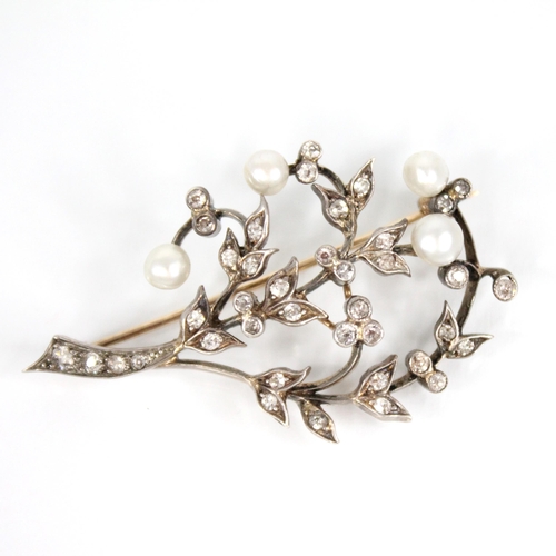 84 - An early 20th century diamond and pearl floral spray brooch, comprising four off-round pearls upon a... 