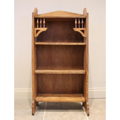 855 - An Arts & Crafts oak bookcase, in the manner of Archibald Knox for Liberty, the open front bookcase ... 