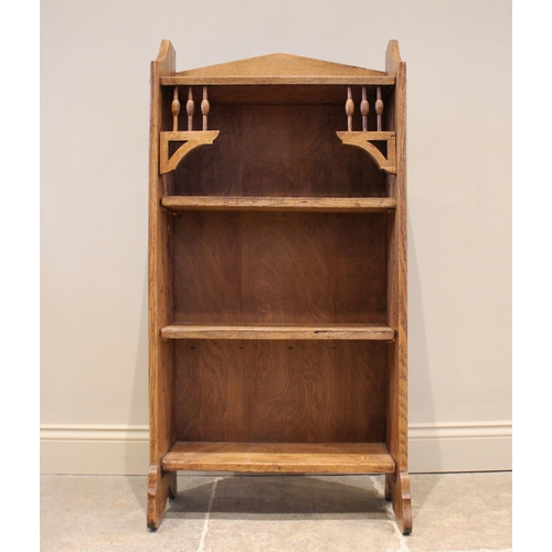 855 - An Arts & Crafts oak bookcase, in the manner of Archibald Knox for Liberty, the open front bookcase ... 