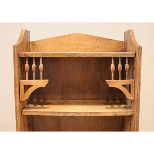 855 - An Arts & Crafts oak bookcase, in the manner of Archibald Knox for Liberty, the open front bookcase ... 