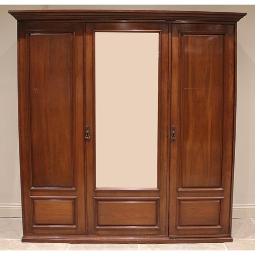 864 - A large Edwardian walnut gentleman's triple wardrobe, the central bevelled mirror door flanked by tw... 