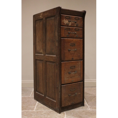 866 - A 1930's oak bank of drawers/filing cabinet, the panelled sides enclosing an arrangement of two shor... 