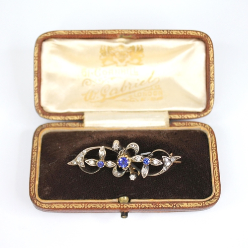 87 - A Victorian sapphire and diamond floral bar brooch, comprising a central round mixed cut sapphire (u... 