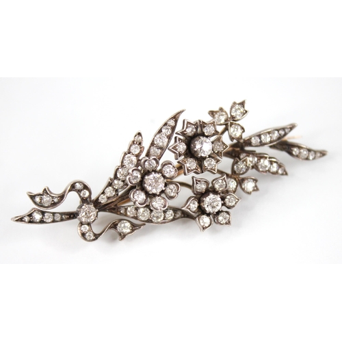 89 - A Victorian diamond floral spray brooch, designed as three flower heads set with old cut diamonds, s... 