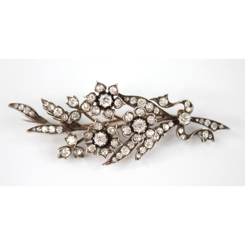 89 - A Victorian diamond floral spray brooch, designed as three flower heads set with old cut diamonds, s... 