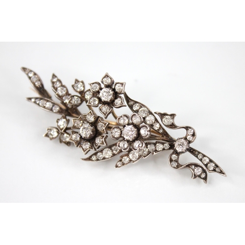 89 - A Victorian diamond floral spray brooch, designed as three flower heads set with old cut diamonds, s... 