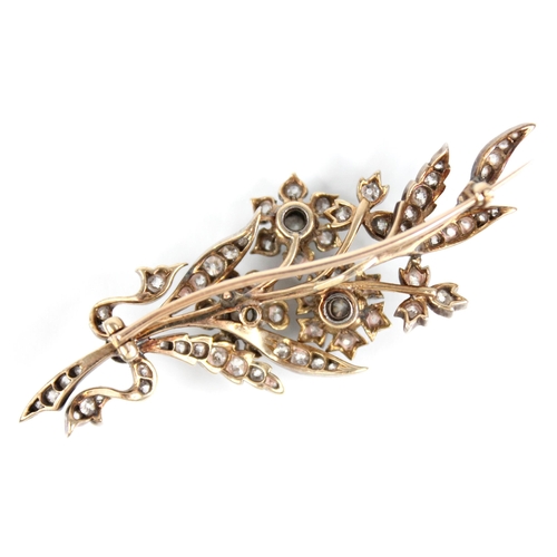 89 - A Victorian diamond floral spray brooch, designed as three flower heads set with old cut diamonds, s... 