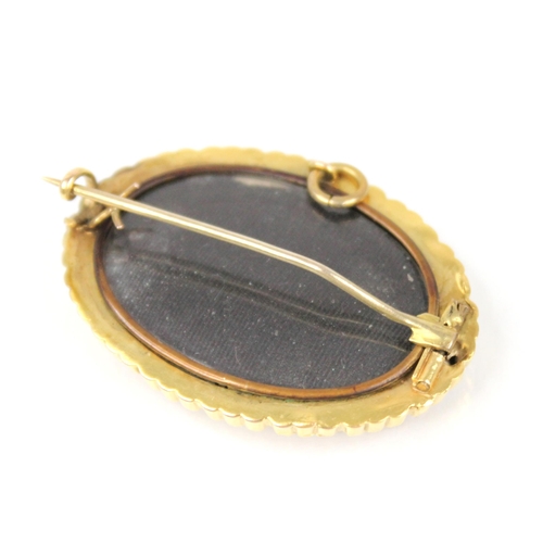 90 - A Victorian diamond set memorial brooch pendant, the central raised oval panel set with a central ro... 