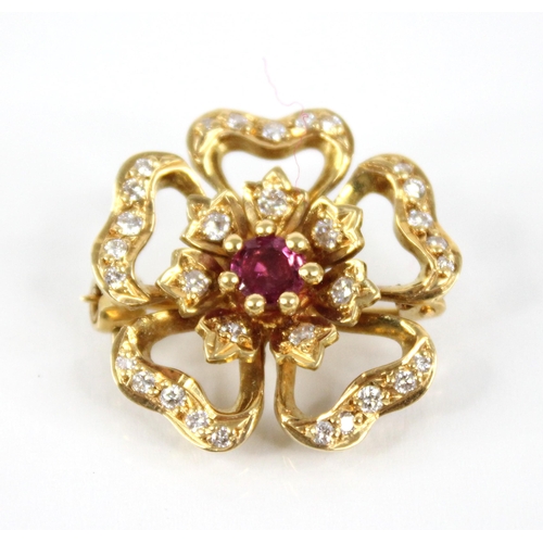 92 - A ruby and diamond 18ct gold floral brooch by Cropp & Farr, the central round mixed cut ruby measuri... 