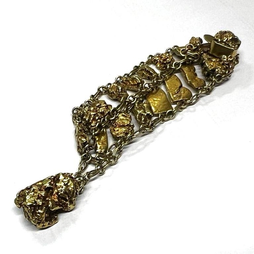 139 - A gold coloured nugget bracelet, designed a graduated row of organic form gold coloured nuggets, sma... 