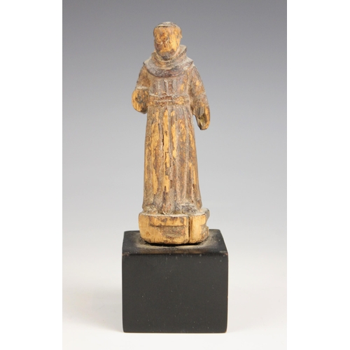 154 - An Indo-Portuguese carving of Saint Francis Assisi, 17th century, modelled standing on an ebonised p... 