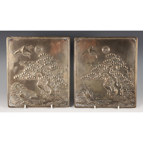 415 - A pair of Japanese polished bronze plaques, Meiji Period (1868-1912), each of rectangular form and d... 