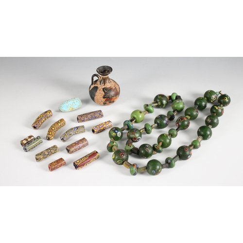 444 - Eleven Venetian glass African trade beads, 19th century, each millefiori bead of tubular form, with ... 