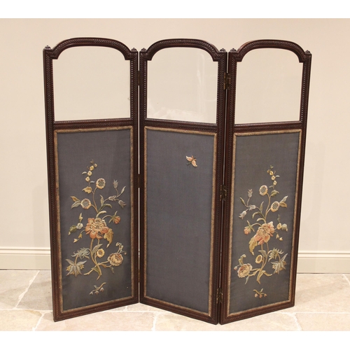 843 - A walnut framed silkwork three panel room screen, circa 1900, each of the three arched sections with... 