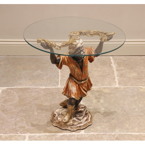 880 - A Blackamoor glass top drinks table, 20th century, the circular glass top raised upon a painted comp... 