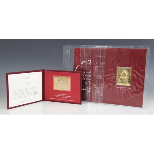 149 - An album of 23 carat gold with 12 carat white gold overlay faux stamps by Heirloom Investments, 