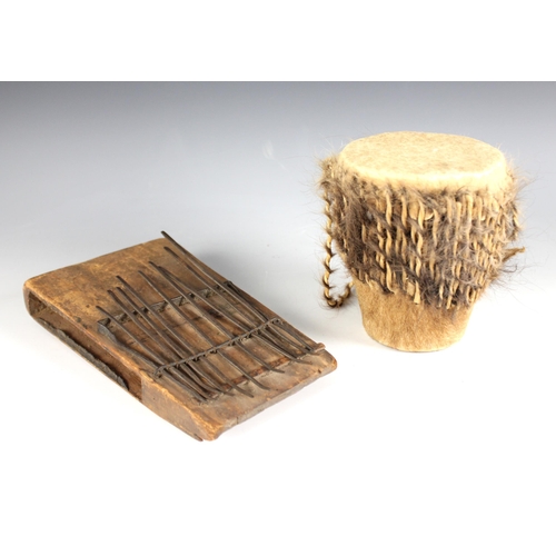 445 - A Belgian Congo Mbera thumb piano (Kalimba), 23cm long, with a West African hide covered djembe/drum... 