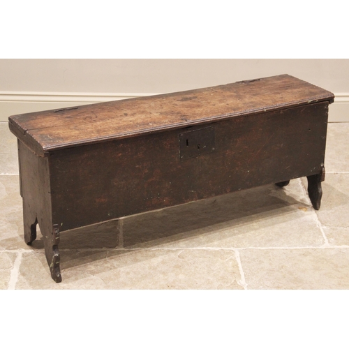 714 - A 17th century oak six plank coffer or sword chest, the hinged top with serrated edges upon wire hin... 