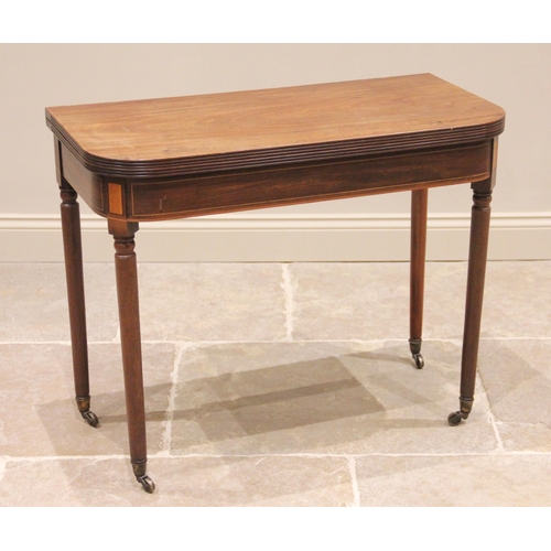 740 - A George III mahogany tea table, the rectangular folding top with rounded corners and a reeded edge,... 