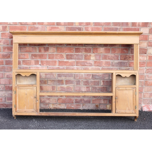 783 - A Victorian pine wall rack, the moulded cornice above a plain frieze and reeded uprights, enclosing ... 