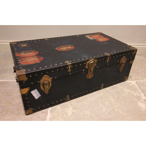 580 - An early 20th century steamer trunk, bearing multiple 'Cunard White Star' labels, applied with rivet... 