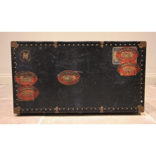 580 - An early 20th century steamer trunk, bearing multiple 'Cunard White Star' labels, applied with rivet... 