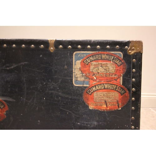 580 - An early 20th century steamer trunk, bearing multiple 'Cunard White Star' labels, applied with rivet... 