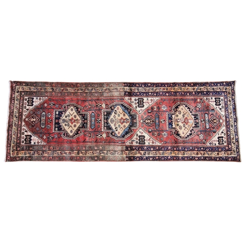 617 - A washed ground Persian runner, the duck egg blue bespoke design, with three central lozenges upon a... 