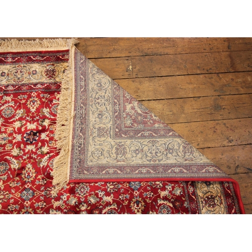 619 - A red ground Kashmir all over floral design, enclosed by a trailing border on a gold ground, 170cm x... 