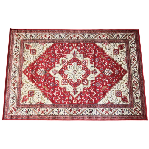 626 - A vibrant red ground Kashmir rug, the traditional medallion design with conforming serrated spandrel... 